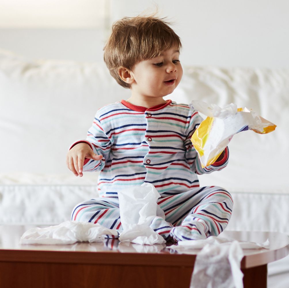 baby sitting on coffee table with wipes