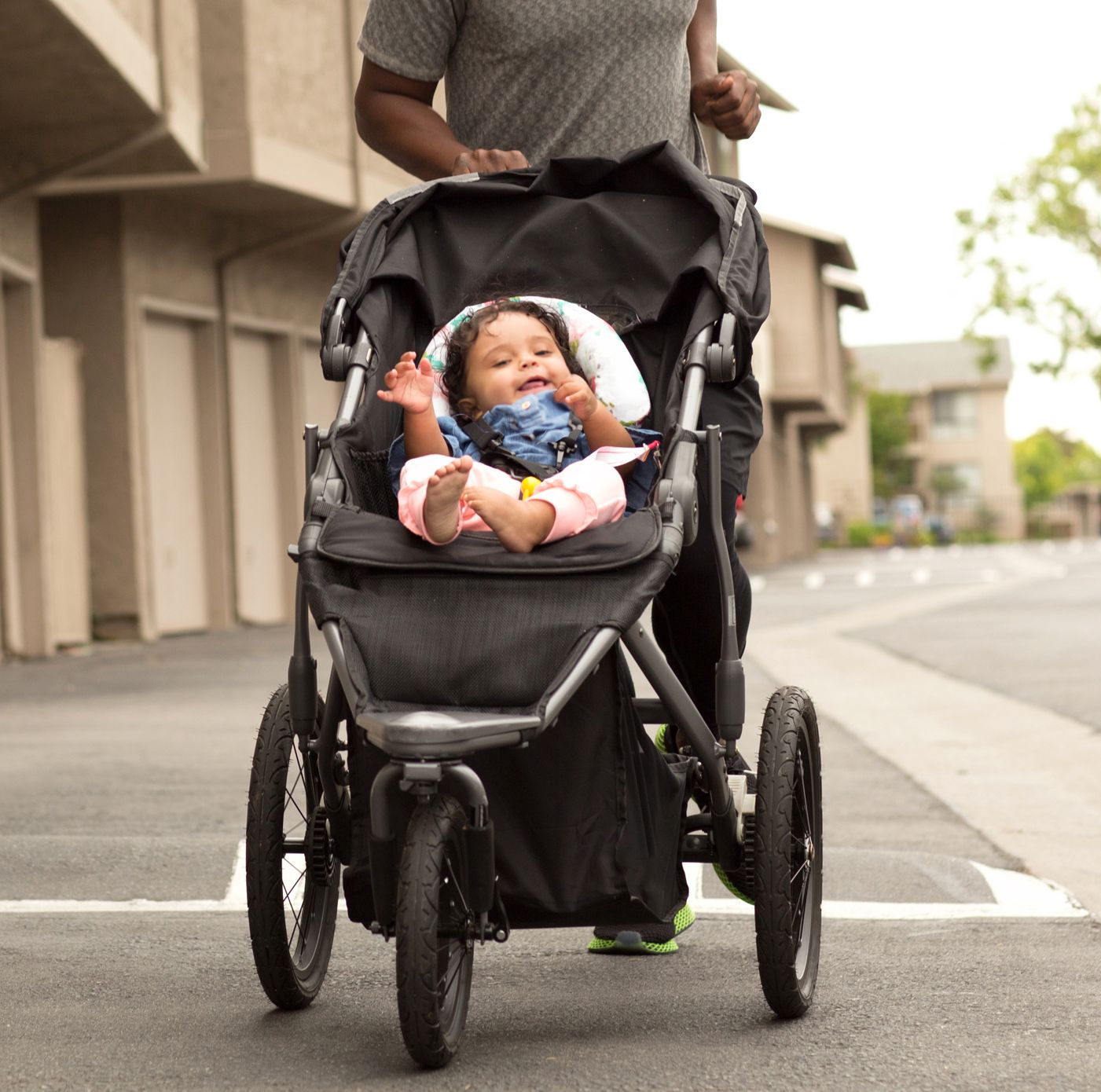 dad pushing baby in jogging stroller