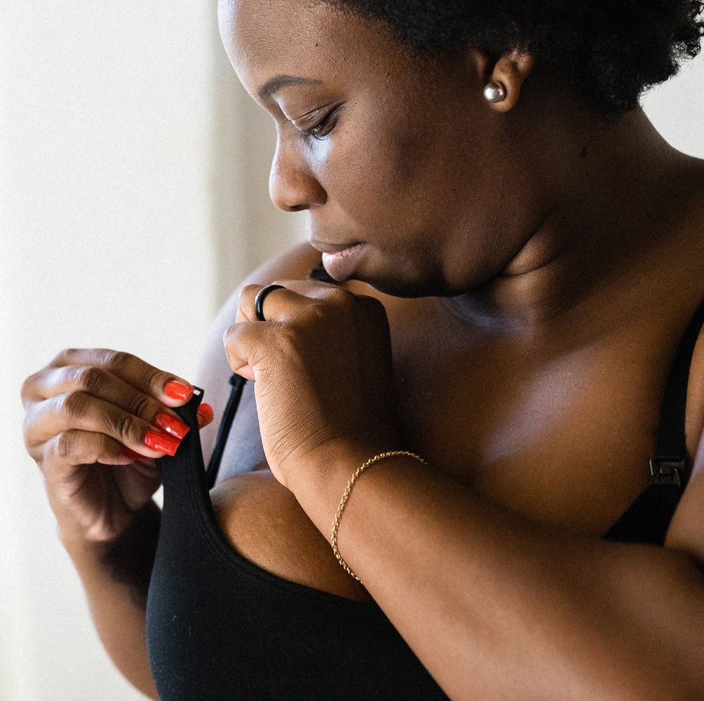 woman adjusting strap of pumping bra