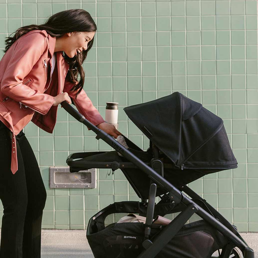 woman pushing baby in uppababy vista stroller